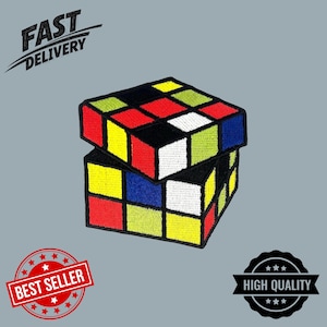 May include: Embroidered patch featuring a colorful Rubik's Cube design. The patch has a black border and squares in red, yellow, blue, green, and white. The words "FAST DELIVERY" are above the cube, and "BEST SELLER" is below.