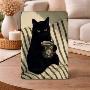 May include: An artistic rendering of a black cat holding a floral-patterned coffee mug. The cat is seated on a striped cushion, with a neutral-toned background. The image is displayed on a tablet or similar device.