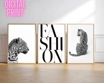 May include: Set of three framed art prints. The prints feature a black and white leopard, the word "FASHION" in bold letters, and a leopard. The phrase "DIGITAL PRINT" is in pink letters in the upper left corner.