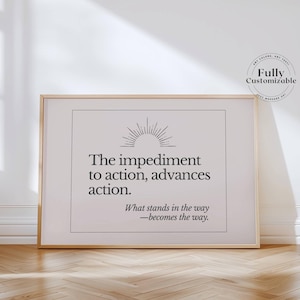 May include: A framed print with a gold-colored frame. The print features the text "The impediment to action, advances action." and "What stands in the way - becomes the way." The top of the print has a sunburst design.