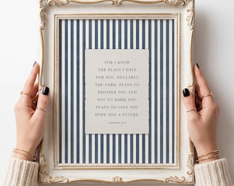 May include: A rectangular wall art piece in an ornate, distressed cream and gold frame. The background features a vertical navy blue and white striped pattern. Centered is a cream-colored card with the text: FOR I KNOW THE PLANS I HAVE FOR YOU, DECLARES THE LORD. PLANS TO PROSPER YOU AND NOT TO HARM YOU. PLANS TO GIVE YOU HOPE AND A FUTURE. JEREMIAH 29:11.