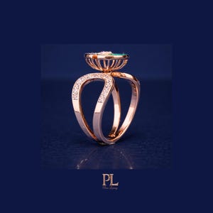 May include: A rose gold ring with a unique design. The ring features a central setting with a teal-colored stone and is adorned with small, sparkling diamonds. The band has a distinctive, open design with diamond accents.