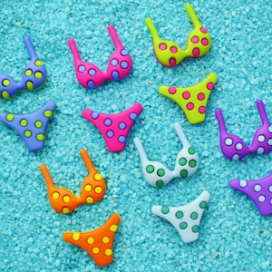 May include: A collection of colorful bikini tops and bottoms with polka dot patterns. The swimwear pieces are in various colors, including pink, green, orange, purple, and blue, set against a light blue background.