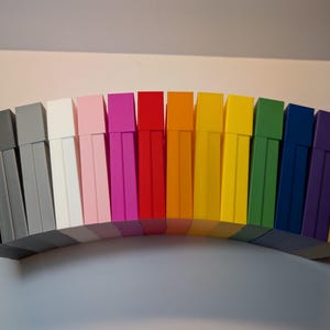 May include: A set of three ceramic mugs with a speckled, matte finish. The mugs are in shades of cream, light gray, and dark gray. Each mug has a simple, minimalist design and a rounded handle. Perfect for coffee or tea.