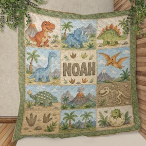 May include: A quilted blanket featuring a grid of nine squares with illustrations of various dinosaurs, including a T-Rex, triceratops, and pterodactyl, alongside palm trees, volcanoes, and a dinosaur skeleton. The center square displays the name NOAH.