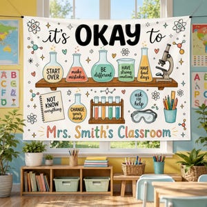 May include: A white fabric wall banner featuring science-themed illustrations and the text "it's OKAY to" above a shelf holding flasks labeled "START OVER", "make mistakes", "BE different", "HAVE strong emotions", and "HAVE bad days". It includes "Mrs. Smith's Classroom" text.