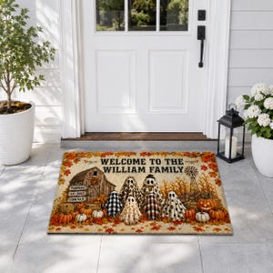 May include: A rectangular doormat featuring a fall-themed scene with a barn, pumpkins, and six ghosts wearing various patterned sheets. The text reads WELCOME TO THE WILLIAM FAMILY. The border is decorated with orange and yellow autumn leaves.