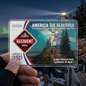 May include: A clear plastic card with the text "AMERICA THE BEAUTIFUL" and "The National Parks and Federal Recreational Lands Pass." The card features a lighthouse illustration and the text "Acadia National Park: Lighthouse At Night."