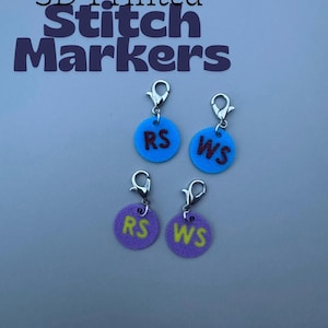 May include: 3D printed stitch markers in blue and purple with silver clasps. Each marker has the initials "RS" or "WS" in contrasting colors. The text "3D Printed Stitch Markers" is at the top of the image.