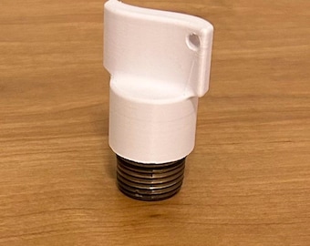 May include: A white, 3D-printed object with a cylindrical base and a curved top. The base has a threaded metal insert. The object has a small hole near the top. The item is likely a component or part of a larger product.