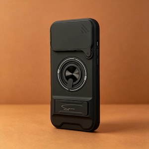 May include: Black phone case with a built-in camera cover and a ring holder. The case has a sleek design with a matte finish. The ring holder is centered and has a metallic appearance. The case also features a kickstand and the name "Sam" is written on the bottom.