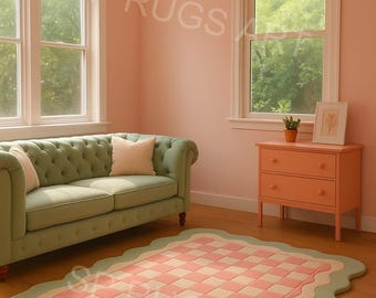May include: A room with a green sofa, peach-colored dresser, and a checkered rug with a scalloped edge. The rug has a pink and cream checkerboard pattern. The walls are a soft peach color.