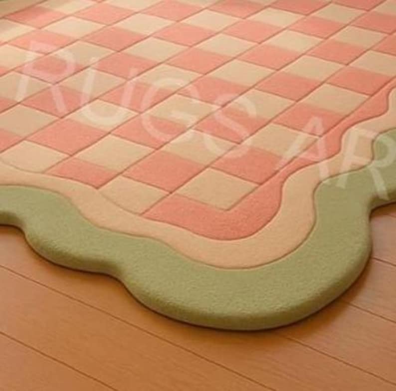 Modern irregular shape rug with soft peach and sage green tones