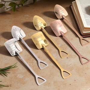 May include: A set of three ceramic nesting bowls in shades of blue, green, and white. The bowls feature a speckled glaze and a simple, modern design. The largest bowl measures approximately 8 inches in diameter.