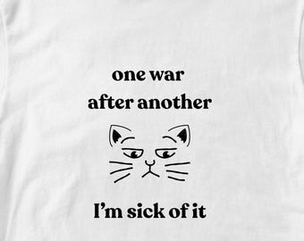 Angry cat pro peace political protest tee. Short sleeved 100% cotton shirt. Unisex classic T-shirt. Sustainable progressive anti-war tshirt.