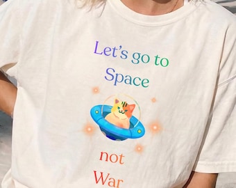 Cat spaceship anti war political tee shirt. Short sleeve 100% cotton casual shirt. Unisex women men T-shirt. Colorful sustainable clothing.
