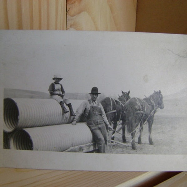 Antique Real Photo Postcard Man and Boy Hauling Pipes with horse-drawn travois, corrugated metal pipe, farmer agriculture working