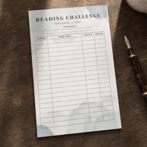 May include: A rectangular reading challenge notepad with a light blue watercolor background. The header reads READING CHALLENGE, I WANT TO READ ___ BOOKS, and PROGRESS. It features a table with columns for AUTHOR, BOOK TITLE, LENGTH, and RATING.