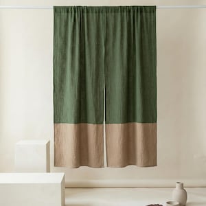 May include: A white ceramic mug with a black handle and the text "But First, Coffee" in a bold, black font. The mug is set against a blurred background, suggesting a cozy setting.