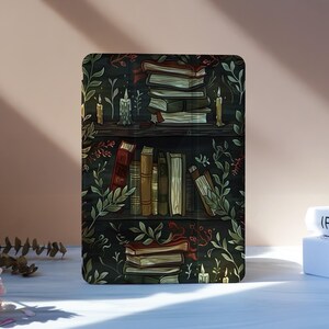 May include: A decorative rectangular item featuring a detailed illustration of a bookshelf filled with books, candles, and foliage. The color palette includes dark greens, browns, and touches of gold, creating a vintage aesthetic. The design evokes a cozy, literary theme.