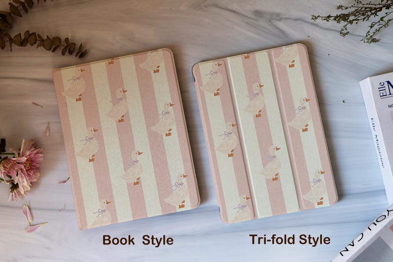 May include: Two tablet cases, one in a book style and the other a tri-fold style, are displayed. Both cases feature a repeating pattern of pink and white vertical stripes with illustrations of ducks. The text "Book Style" and "Tri-fold Style" are visible.