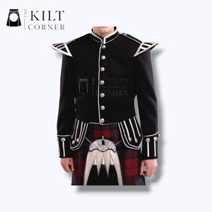 May include: Black jacket with white trim and silver buttons. The jacket has shoulder accents and is paired with a traditional tartan kilt. The Kilt Corner logo is in the upper left corner.