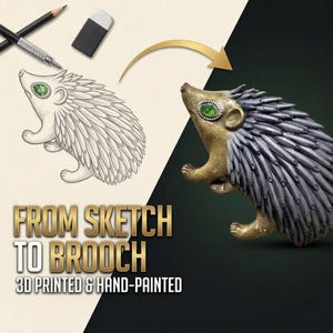 May include: A hedgehog brooch featuring a gold-toned head and limbs with a textured gray back, accented by a single green faceted eye. The image displays a pencil sketch of the hedgehog alongside the finished brooch with the text FROM SKETCH TO BROOCH 3D PRINTED & HAND-PAINTED.
