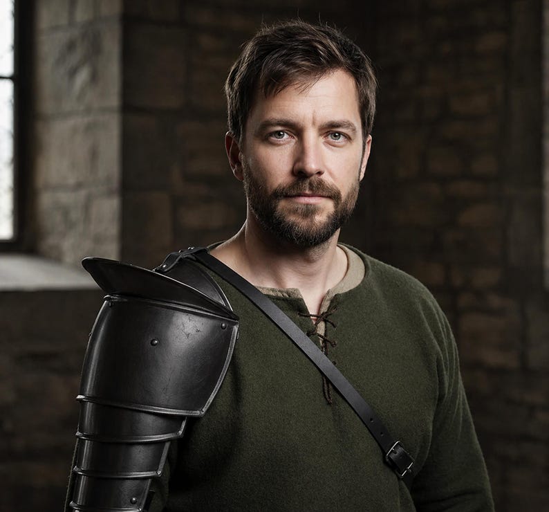 May include: A man wearing a dark green tunic and black shoulder armor. The armor is made of layered metal plates. A black leather strap crosses the chest. The background is a stone wall with a window.
