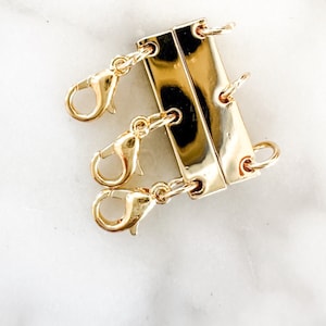 May include: Gold-toned metal clasp with three attached gold-toned metal lobster clasps.