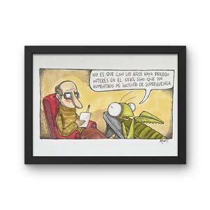 May include: Framed cartoon print depicting a therapy session with a therapist and a praying mantis. The therapist, wearing glasses, sits in a red chair, holding a notepad. The mantis is on a couch, with a speech bubble containing text in Spanish. The frame is black.