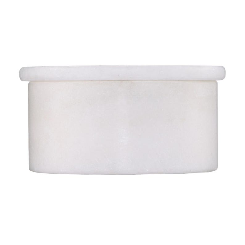 May include: A cylindrical white marble container with a smooth, polished finish and a matching circular lid. The vessel features a clean, minimalist design with a slightly protruding rim at the top, showcasing the natural stone texture and color.