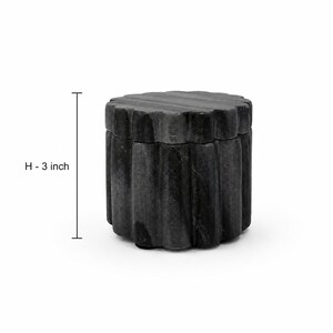 May include: A cylindrical dark grey stone container with a scalloped, fluted exterior texture and a matching lid. The object features a vertical measurement indicator labeled H - 3 inch, clearly showing a height of 3 inches for the container.