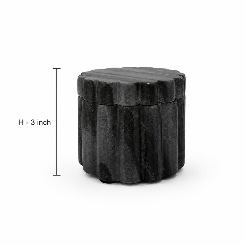 May include: A cylindrical dark grey stone container with a scalloped, fluted exterior texture and a matching lid. The object features a vertical measurement indicator labeled H - 3 inch, clearly showing a height of 3 inches for the container.
