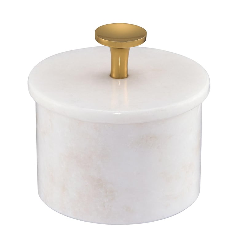 May include: A cylindrical white marble container with a smooth, polished finish and subtle light pink veining. The container features a matching circular lid topped with a small, centered, metallic gold-toned knob handle for easy lifting.