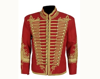 May include: A red military-style jacket with gold-colored embellishments. The jacket features a high collar, gold braid trim, and rows of gold buttons. Intricate gold embroidery adorns the shoulders and cuffs, creating a formal and ornate appearance.