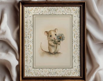 May include: A framed wall art print featuring a light brown mouse holding a blue flower. The print is set within a dark brown frame and includes a decorative border with small blue and yellow floral patterns. The text Attic Curations is visible.