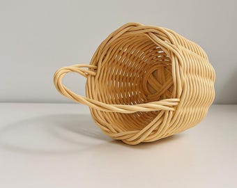 Cesta tejida a mano con asa: cesta decorativa y de almacenamiento de estilo ratán natural.