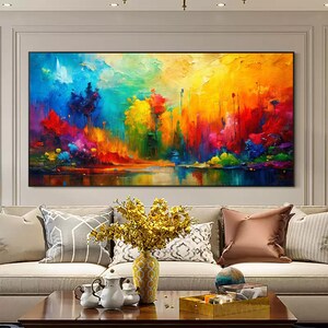 May include: A large, rectangular abstract painting with vibrant colors. The artwork features a landscape with a lake reflecting a colorful sky and trees. The color palette includes blues, yellows, reds, and greens, creating a dynamic and expressive piece.