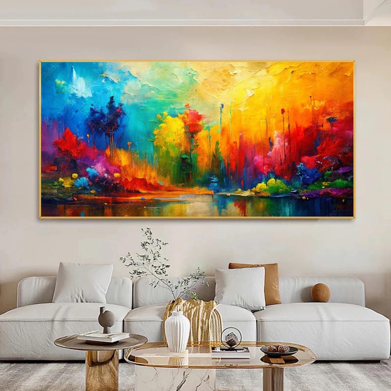 May include: A vibrant abstract landscape painting with a gold frame. The artwork features a colorful scene with a lake reflecting the sky and trees. The color palette includes blues, yellows, reds, and greens, creating a lively and dynamic composition.