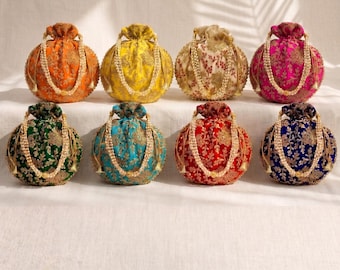 May include: Eight round drawstring pouches in orange, yellow, cream, magenta, green, teal, red, and navy blue. Each pouch features intricate gold floral embroidery and a beaded handle made of small white pearls, creating a uniform collection.