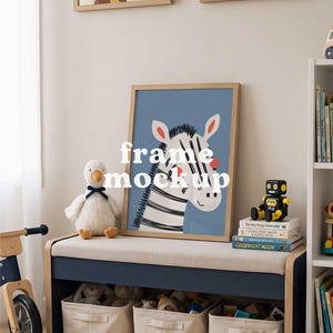 May include: A framed zebra print with a blue background is displayed above a bench with storage baskets. A plush duck, a toy robot, and books are on the bench. The text "frame mockup" is overlaid on the image. The room has a neutral color palette.