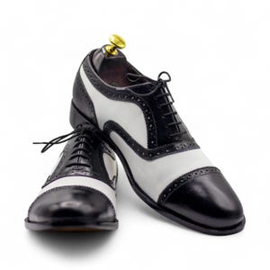 Front view of handmade men’s white & black Cap Toe Oxford leather shoes, perfect for formal occasions and office wear, USA 10.5 available.