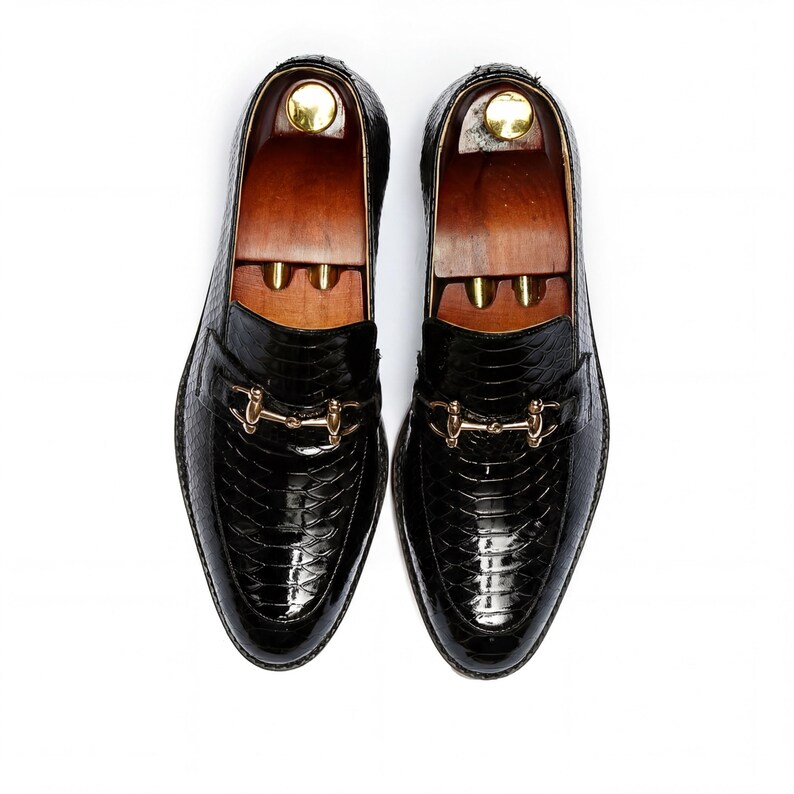 Close up texture of UV printed snake scale leather shoes black