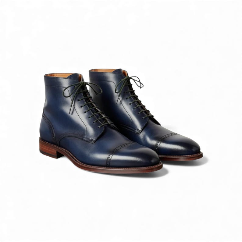 Pair of handmade blue leather cap toe brogue men's dress boots.