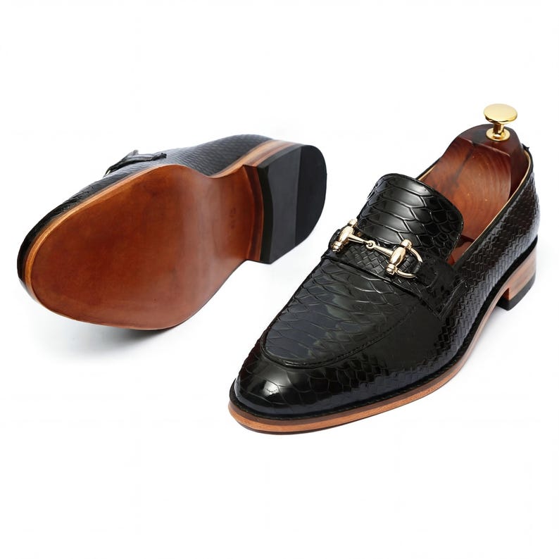 Side profile of mens dress loafers on wooden shelf Leathersmerchant