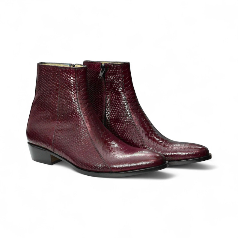 Close-up of Burgundy python texture on handmade boots, showcasing luxury leather detailing and high-quality craftsmanship.