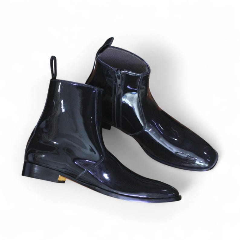 Side View: Side profile showcasing sleek patent leather finish and side zipper for a modern twist on classic ankle boots.