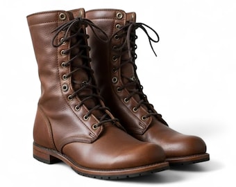 May include: A pair of brown leather combat boots. The boots have a lace-up design with metal eyelets and a rounded toe. The boots are made of a smooth, polished leather and have a sturdy sole.
