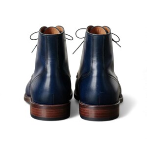 Rear view showcasing dark blue full grain leather formal men's boots.