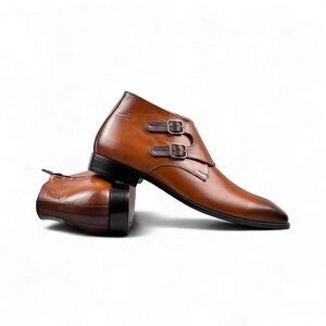 Side view showcasing sleek brown or black leather with double monk strap closure for a modern yet classic look.